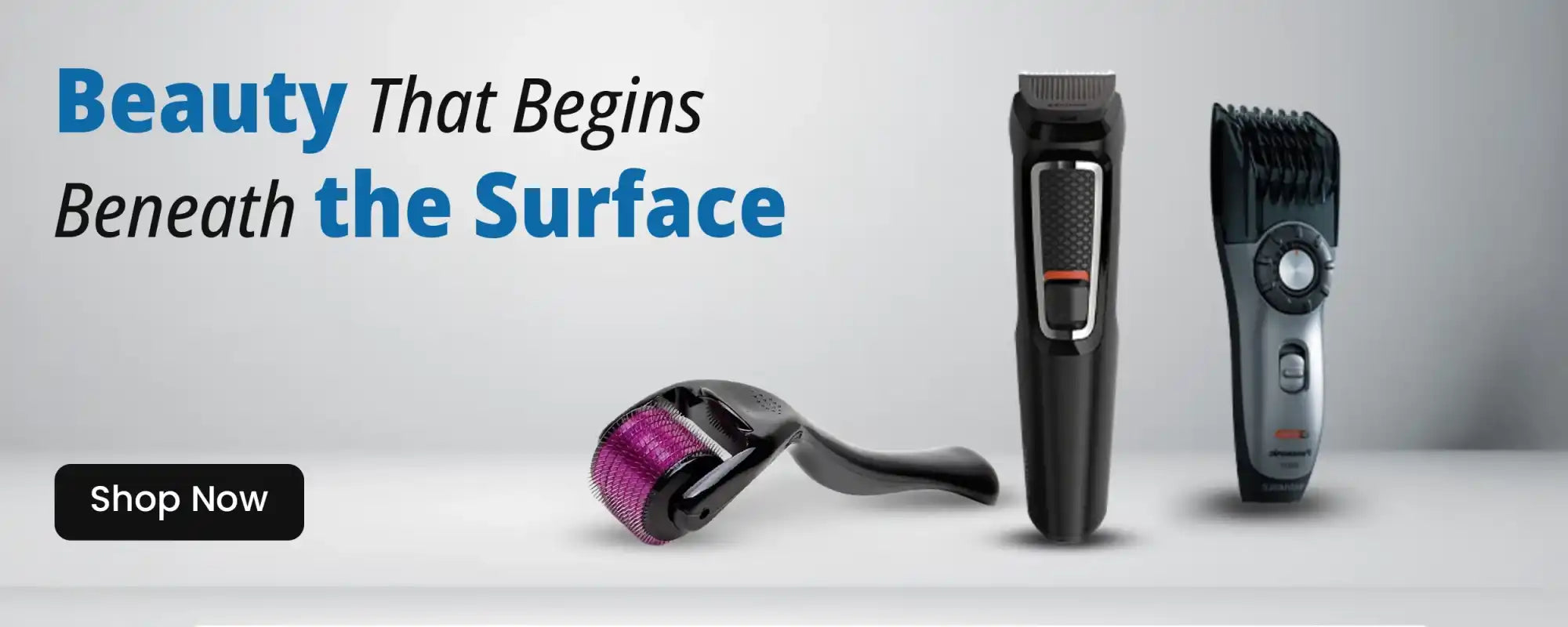 A derma roller and two electric trimmers for personal grooming.